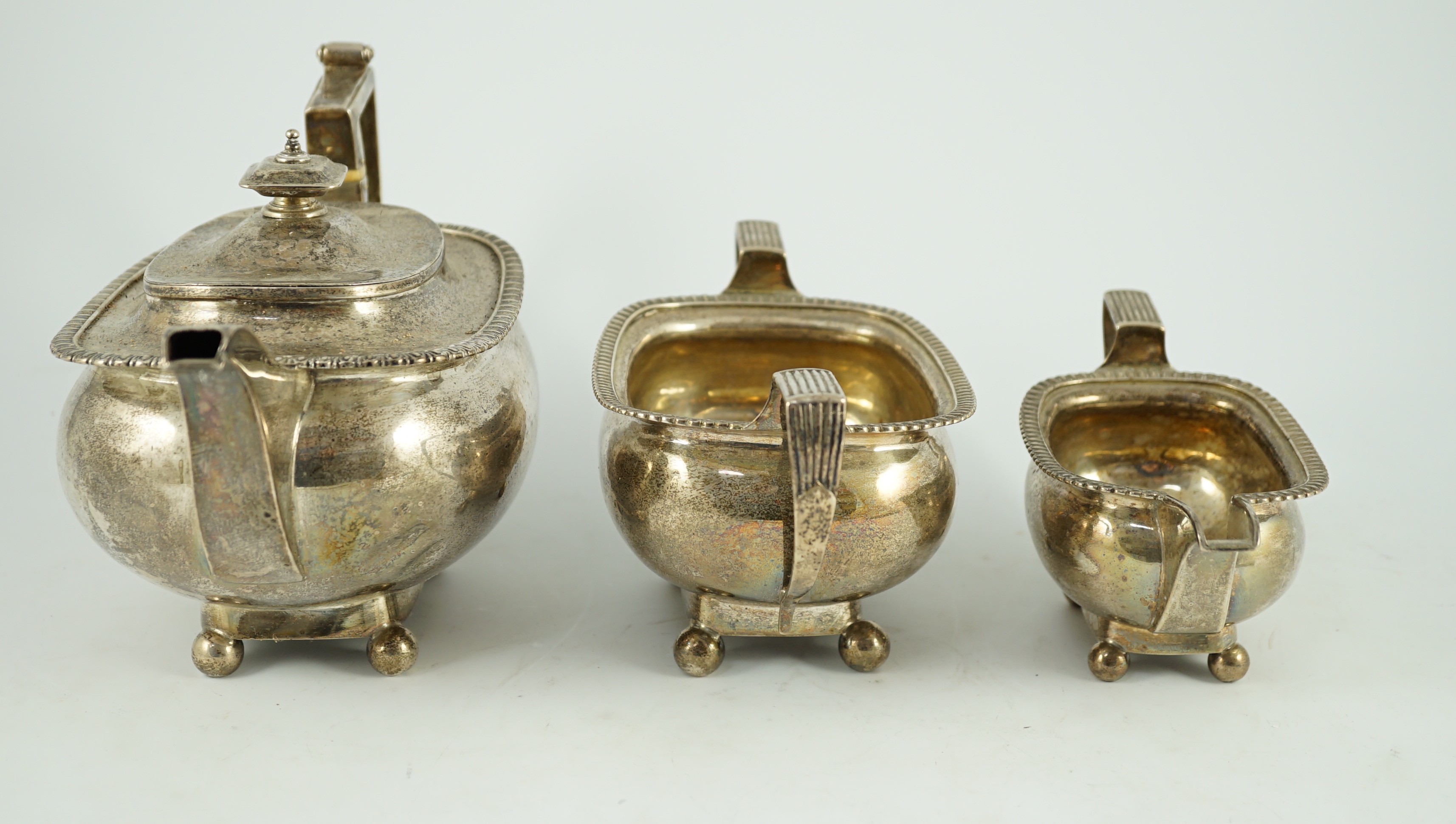 A George III silver three piece 'London' shape tea service, by Samuel Hennell